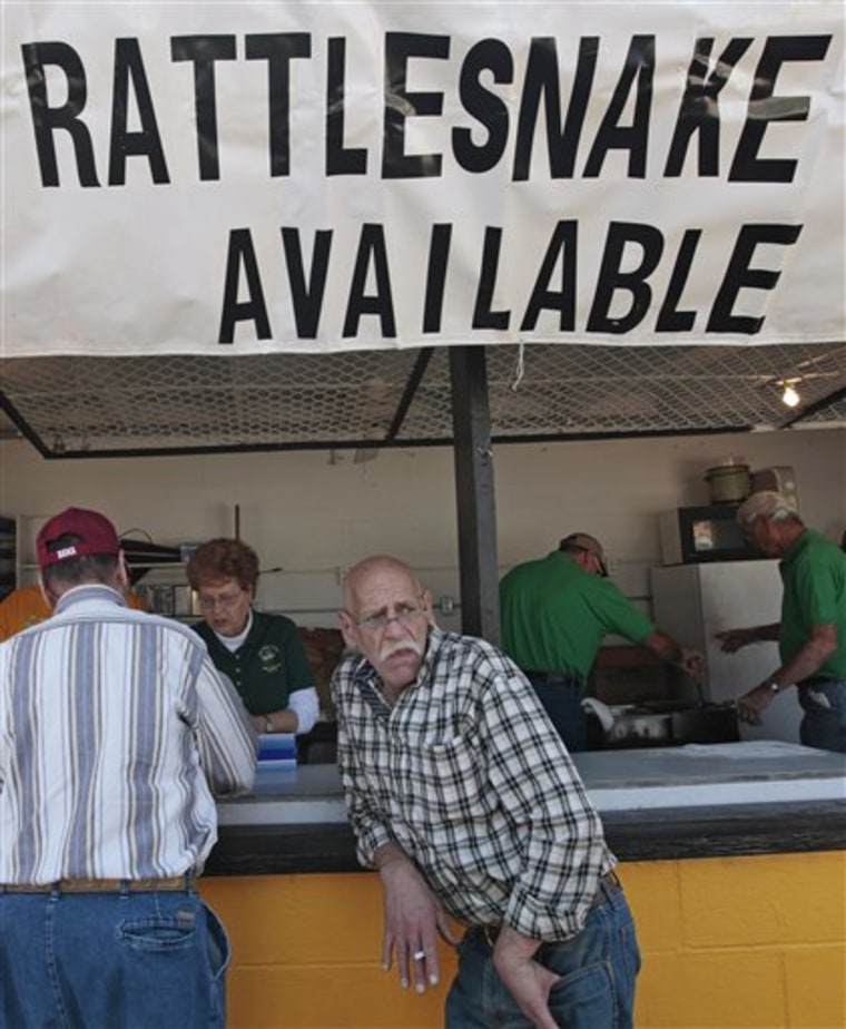 Patrons wait in line for a taste of fried rattlesnake during the 50th annual Rattlesnake Rodeo in Opp, Ala., Tuesday, March 8, 2010. Once there were about 50 snake roundups in the South, but only three are left _ the one in Alabama and two in Georgia. (AP Photo/Dave Martin)